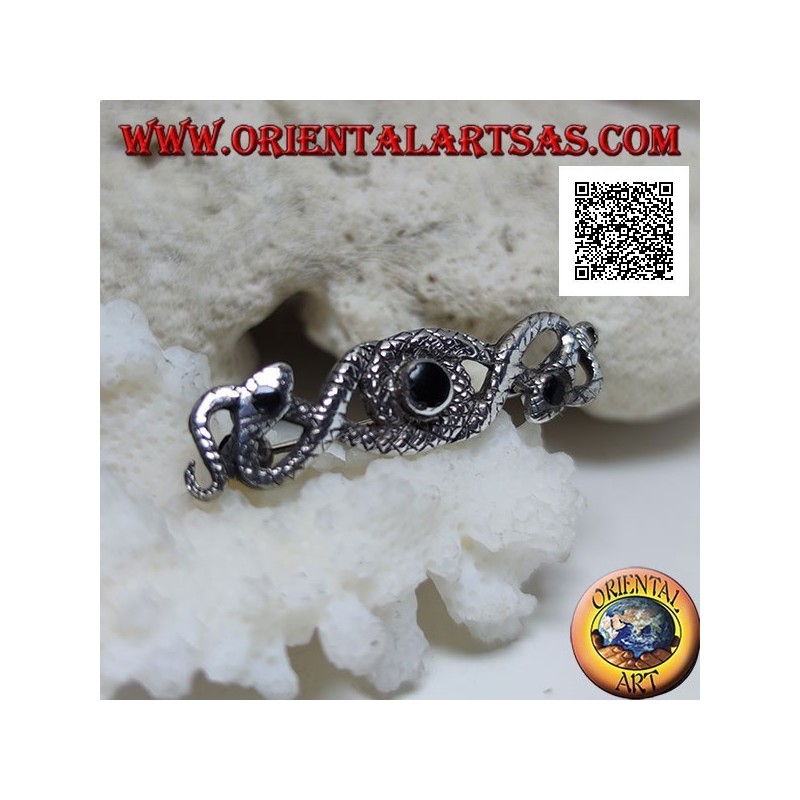 Broche de plata en forma de dos serpientes entrelazadas con ónix central y en los ojos