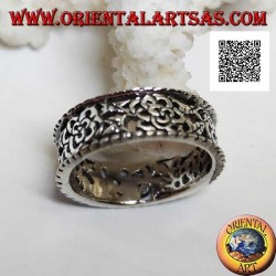 Silver ring with a dense openwork floral pattern and protruding edges