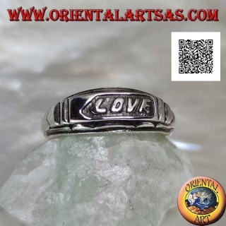 Silver ring with "LOVE" writing in bas-relief on a plate