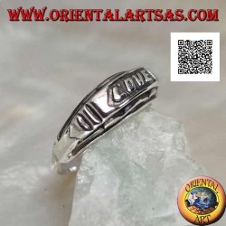 Silver ring with "LOVE" writing in bas-relief on a plate