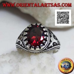 Silver ring with faceted oval garnet with imperial motif engraved on the sides