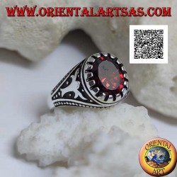 Silver ring with faceted oval garnet with imperial motif engraved on the sides