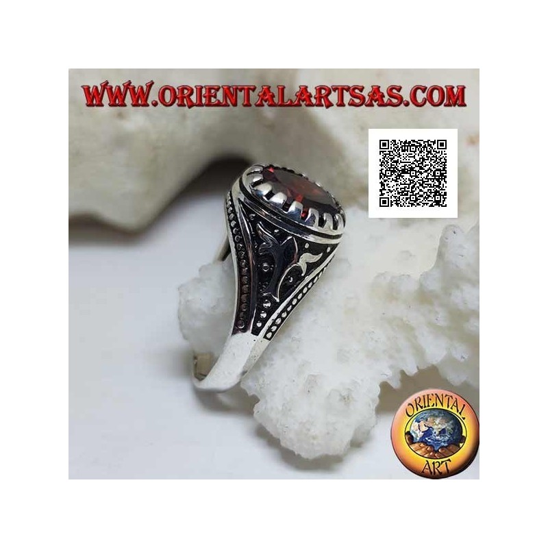 Silver ring with faceted oval garnet with imperial motif engraved on the sides