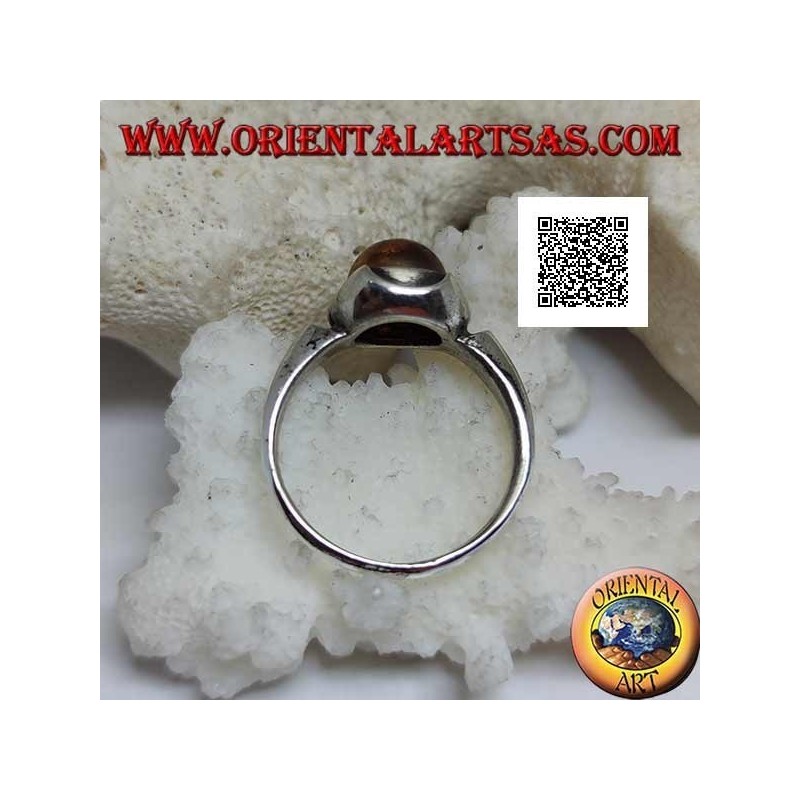 Silver ring with round cabochon amber surrounded by semicircles on a smooth setting