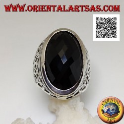 Silver ring with large oval faceted onyx and wavy openwork decoration on the sides