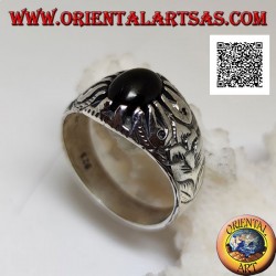 Silver ring with oval cabochon onyx set with claws and embossed floral decorations on the sides