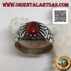 Silver ring with cabochon oval carnelian set with claws and floral decorations in relief on the sides