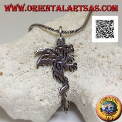 Silver pendant in the shape of a wyvern (two-legged winged dragon) in a tribal style profile