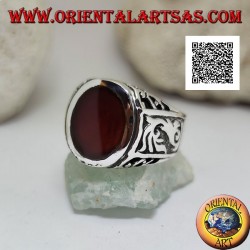 Silver ring with oval carnelian flush with the edge with gothic decorations in bas-relief on the sides