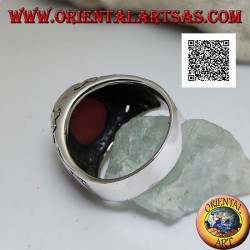 Silver ring with oval carnelian flush with the edge with gothic decorations in bas-relief on the sides