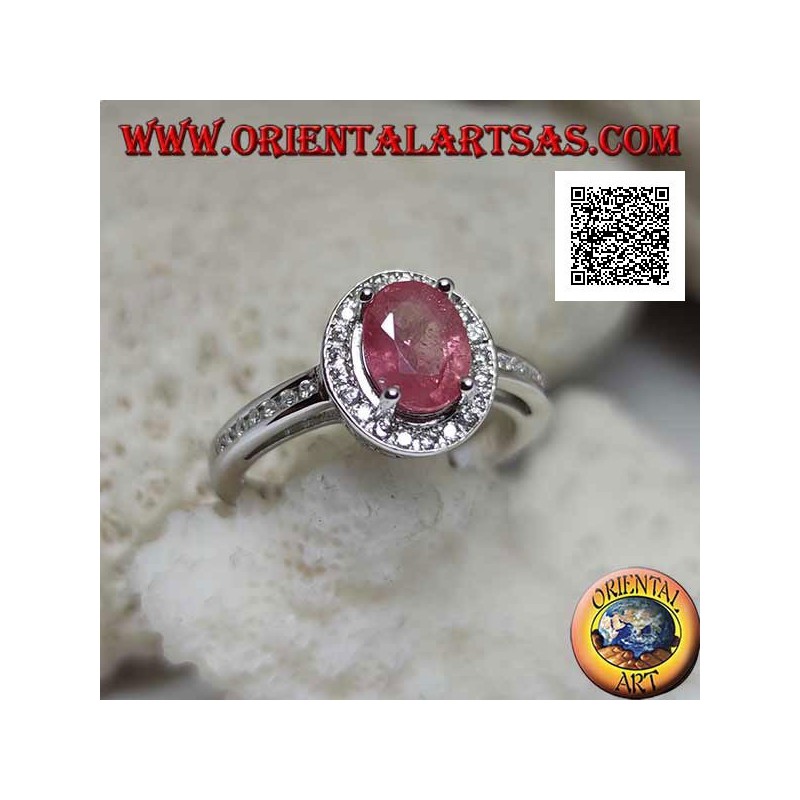 Silver ring with oval natural ruby set with white zircons around and on the side