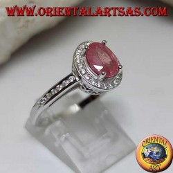 Silver ring with oval natural ruby set with white zircons around and on the side