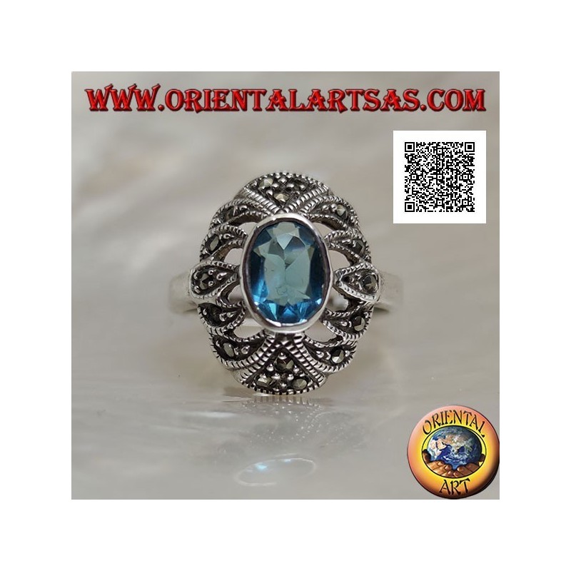 Anillo de plata con topacio azul ovalado sobre un óvalo convexo perforado tachonado de marcasita