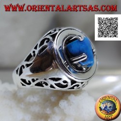 Silver ring with turquoise pyramid set on a smooth disc with floral openwork on the sides