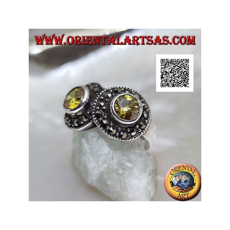Anillo de plata con dos topacios amarillos redondos en dos círculos tachonados de marcasita que se cruzan