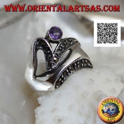 Silver ring of abstract shape in futuristic style with parts of marcasite and round amethyst