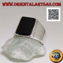Anillo de plata con ónix rectangular en relieve con borde ligeramente rayado sobre un marco liso