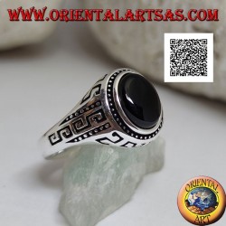 Silver ring with oval cabochon onyx surrounded by disks and S engraved on the sides