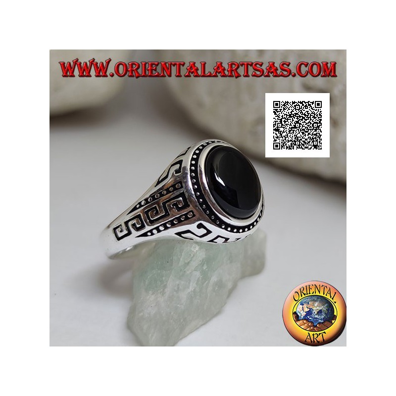 Silver ring with oval cabochon onyx surrounded by disks and S engraved on the sides
