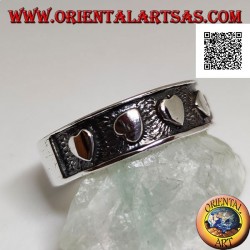 Silver ring with smooth hearts in randomly oriented bas-relief