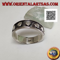 Silver ring with smooth hearts in randomly oriented bas-relief