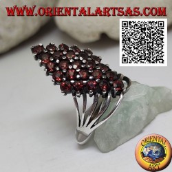 Silver ring with a rhombus of round garnets set at the bottom hooked by four wires
