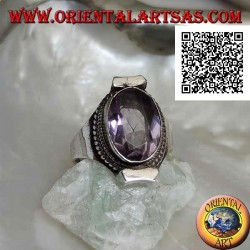 Silver ring with natural oval faceted amethyst surrounded by weaving on Nepalese setting