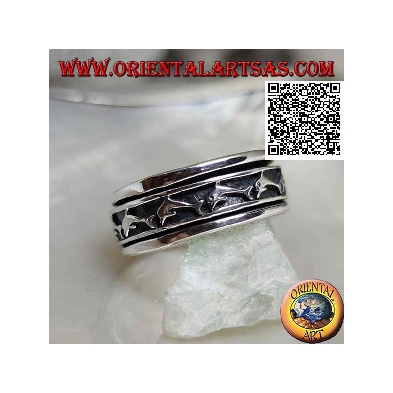 Anti-stress rotating silver ring, with a series of jumping dolphins in bas-relief