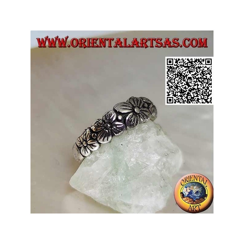 Anillo de plata con banda grabada con fila creciente de flores de cuatro pétalos en relieve