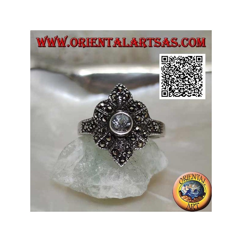 Silver ring with round aquamarine on a six-petal flower studded with marcasite