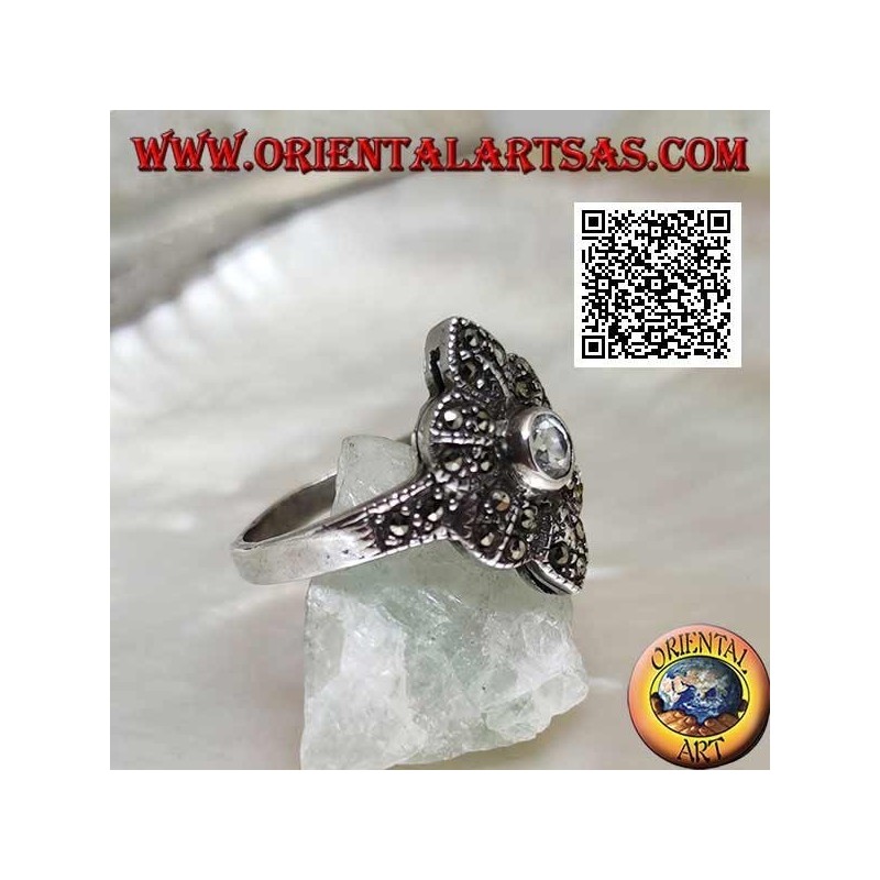 Silver ring with round aquamarine on a six-petal flower studded with marcasite