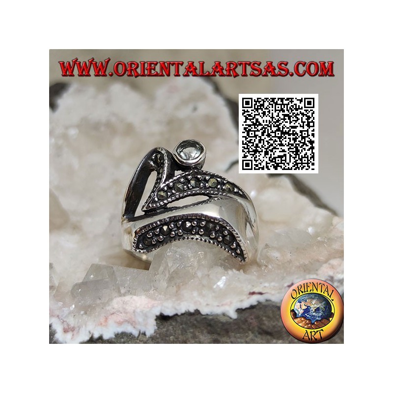 Silver ring of abstract shape in futuristic style with parts of marcasite and round aquamarine