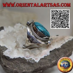 Silver ring with oval turquoise surrounded by interlacing on Nepalese setting and engravings on the sides
