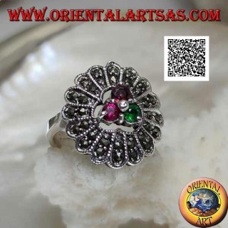Silver flower ring with trio of central ruby and emerald colored zircons and long marcasite petals