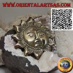 Nepalese pendant in the shape of a sun with a face in relief in brass