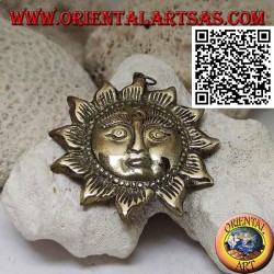 Nepalese pendant in the shape of a sun with a face in relief in brass