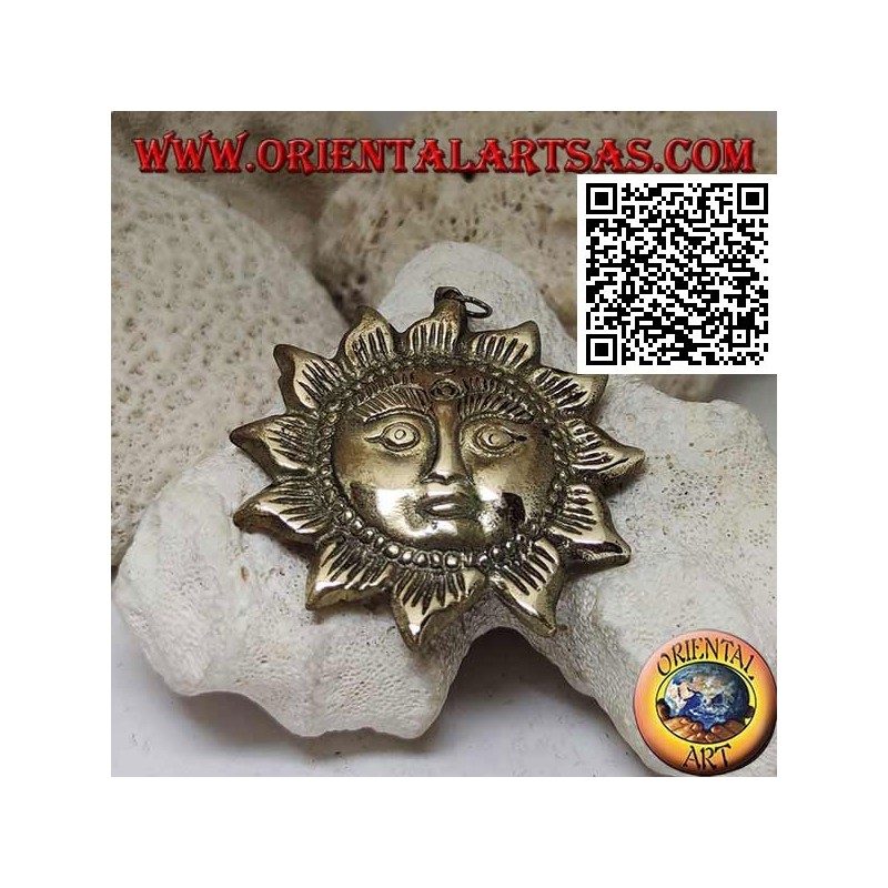 Nepalese pendant in the shape of a sun with a face in relief in brass