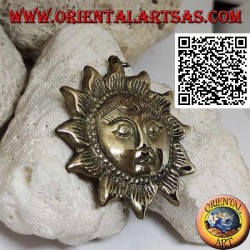 Nepalese pendant in the shape of a sun with a face in relief in brass