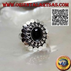 Silver ring with oval cabochon onyx surrounded by balls and discs