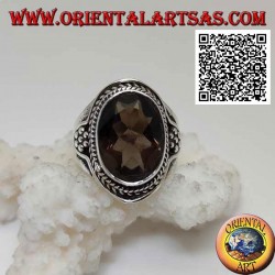 Silver ring with oval faceted smoky topaz surrounded by interweaving and hexagon of balls on the sides