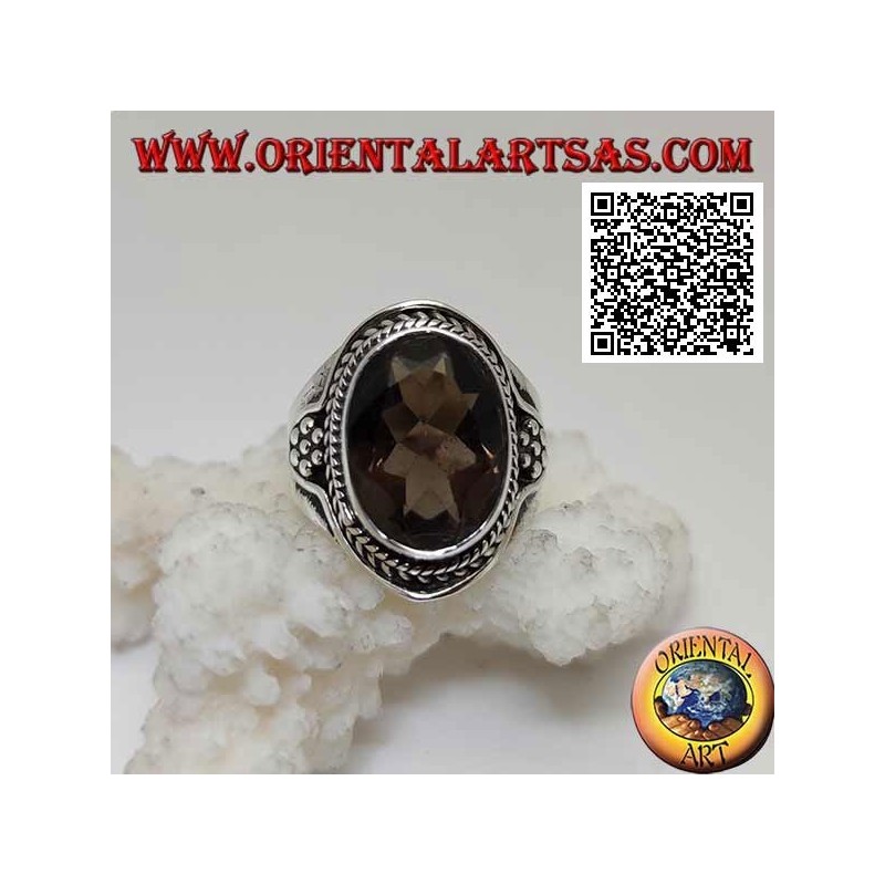 Silver ring with oval faceted smoky topaz surrounded by interweaving and hexagon of balls on the sides