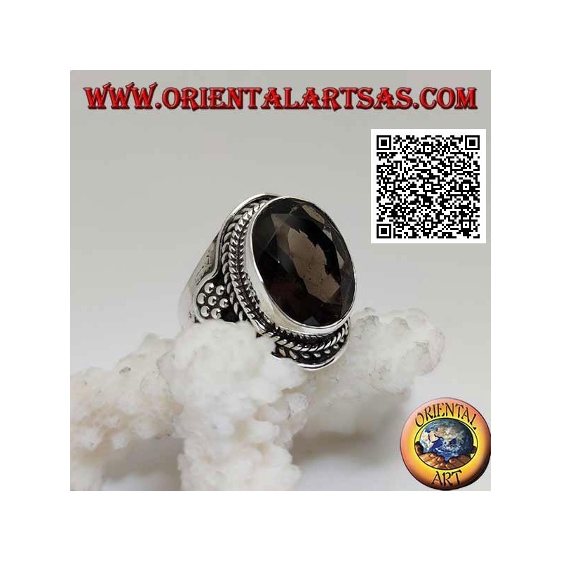 Silver ring with oval faceted smoky topaz surrounded by interweaving and hexagon of balls on the sides