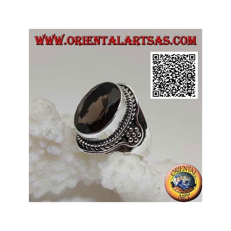 Silver ring with oval faceted smoky topaz surrounded by interweaving and hexagon of balls on the sides