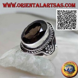 Silver ring with oval faceted smoky topaz surrounded by interweaving and hexagon of balls on the sides