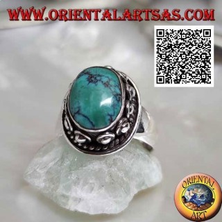 Silver ring with antique oval Tibetan turquoise surrounded by interweaving and ball in the donut
