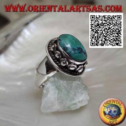 Silver ring with antique oval Tibetan turquoise surrounded by interweaving and ball in the donut