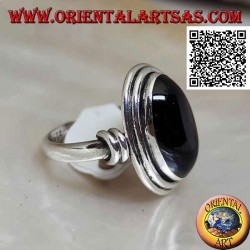 Silver ring with oval onyx surrounded by smooth discs at various levels