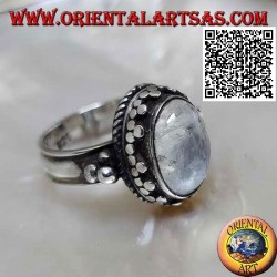 Silver ring with oval rainbow moonstone with tris rim and balls and intertwining