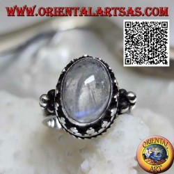 Silver ring with oval rainbow moonstone with tris rim and balls and intertwining
