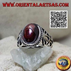 Silver ring with oval cabochon garnet on a setting with large floral openwork